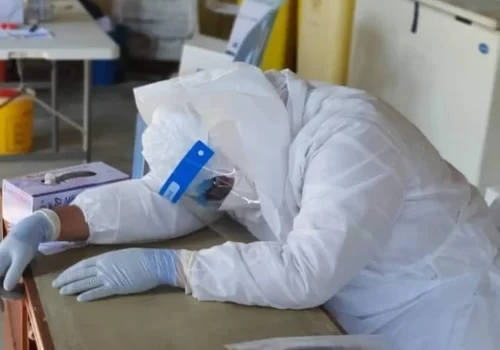 A medical stff is lying at table to get some rest