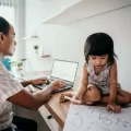 A parent working from home wiith a young child