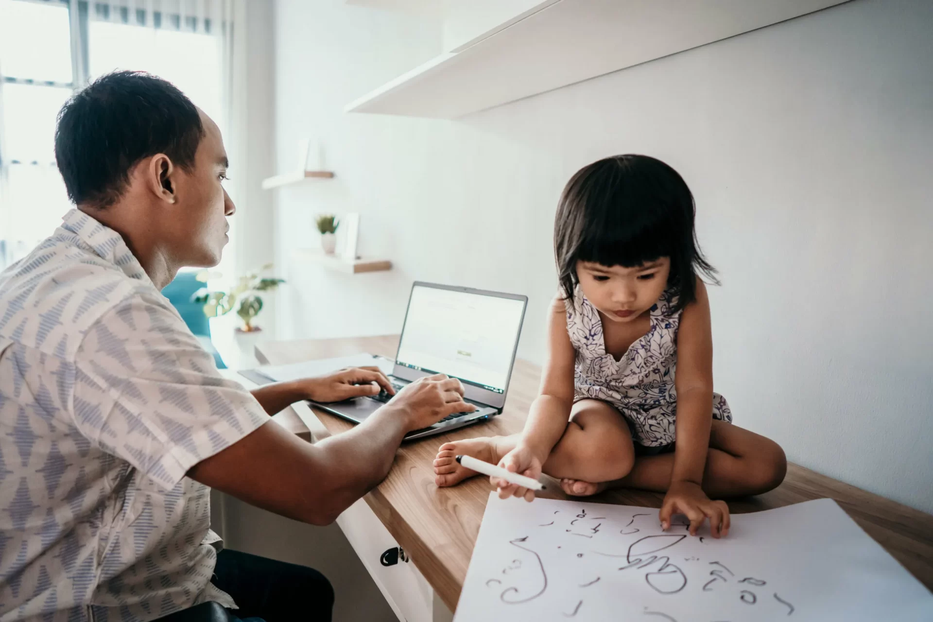 A parent working from home wiith a young child