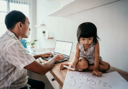 A parent working from home wiith a young child