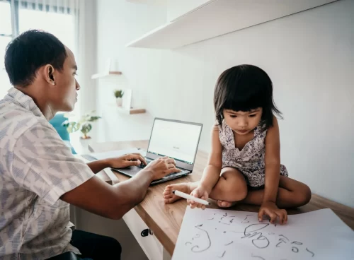 A parent working from home wiith a young child