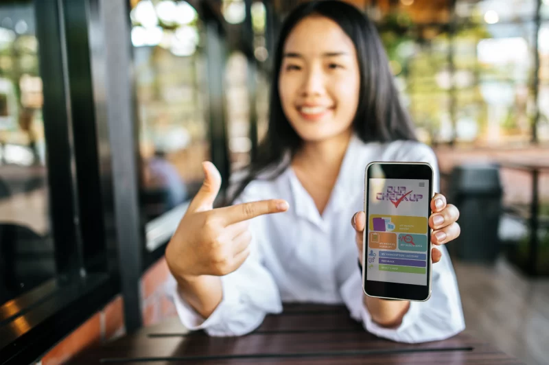 A girl showing the application of OurCheckup