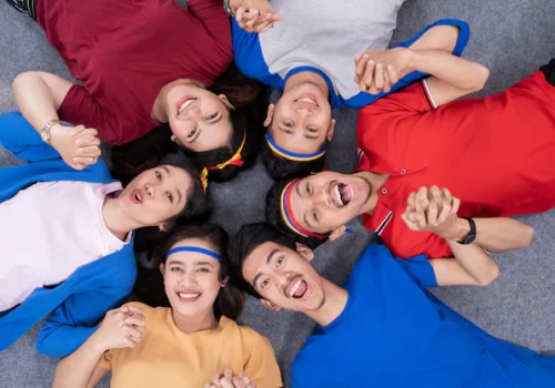 People lying in circle and look at camera