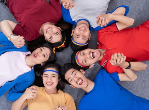 People lying in circle and look at camera