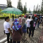 Malaysian queue beside the road