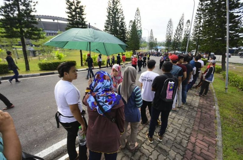 Malaysian queue beside the road