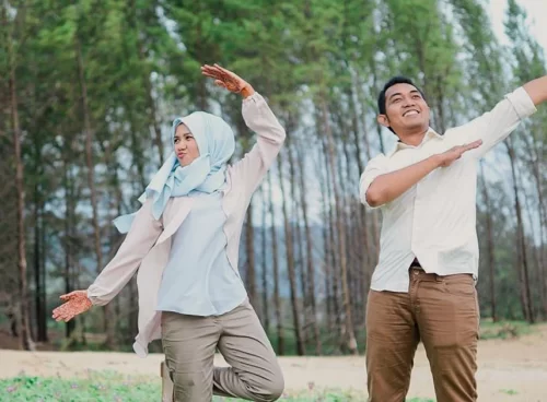 Muslim husband and wife doing outdoor exercise together