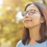 A girl is deeply breathing the fresh air