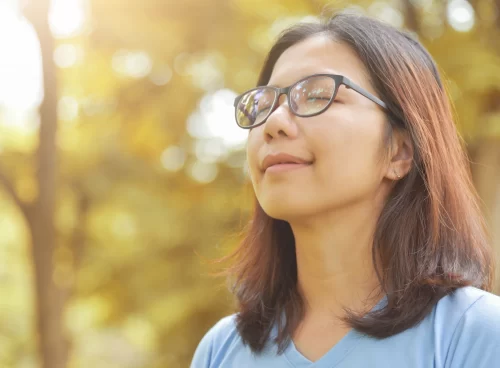 A girl is deeply breathing the fresh air