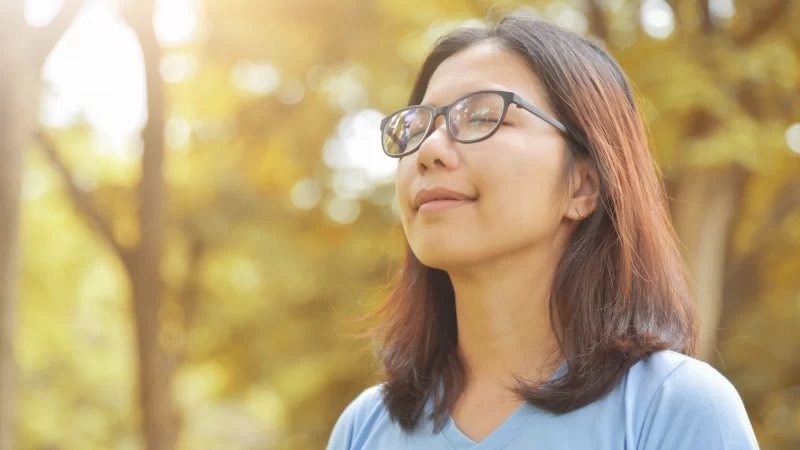 A girl is deeply breathing the fresh air